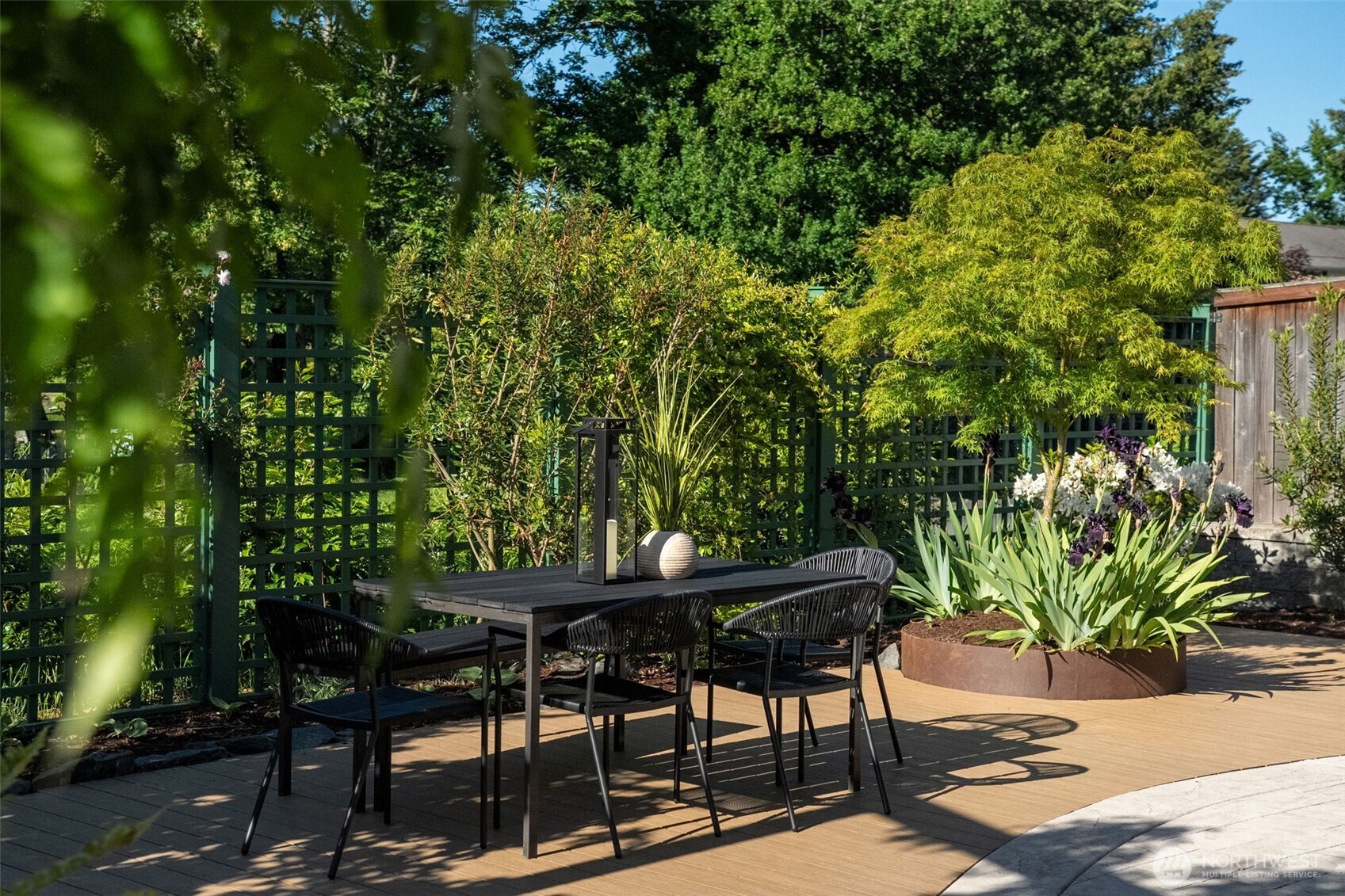 503 5th Street Steilacoom, WA 98388 - Photo 33 of 40 a view of a backyard with table and chairs and potted plants