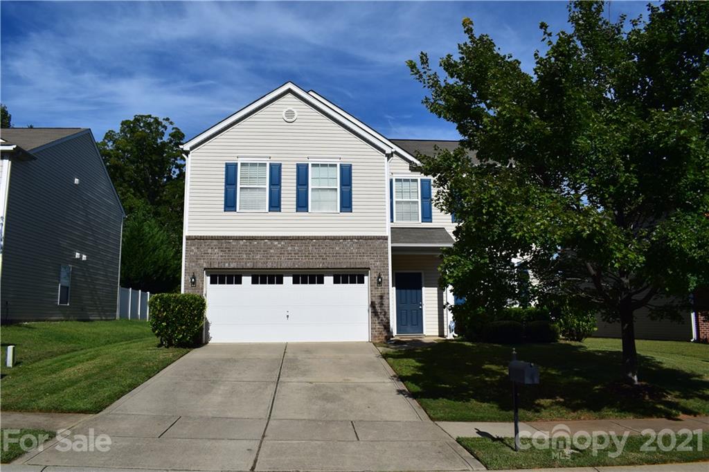 12021 Bending Branch Road Charlotte, NC 28227 - Photo 1 of 16 a front view of a house with a yard and garage