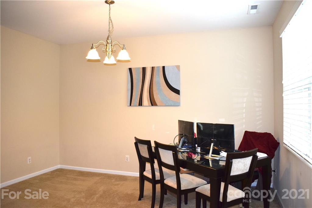 12021 Bending Branch Road Charlotte, NC 28227 - Photo 3 of 16 a view of a dining room with furniture and wooden floor