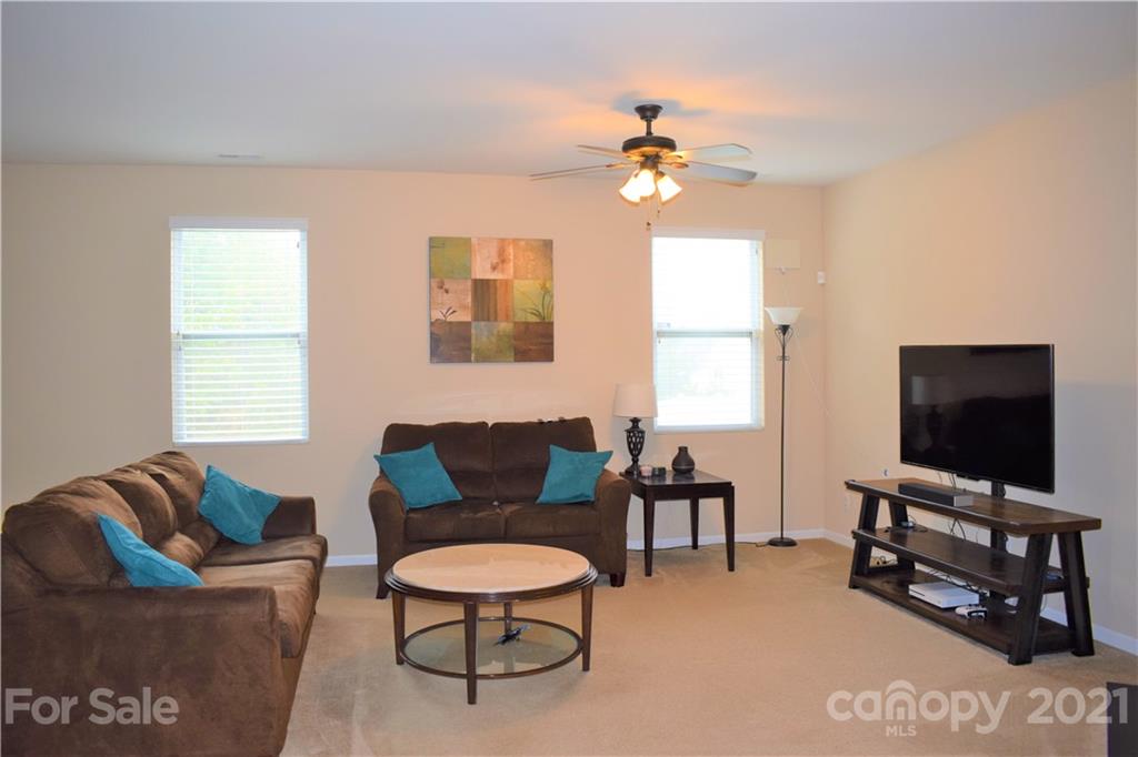 12021 Bending Branch Road Charlotte, NC 28227 - Photo 4 of 16 a living room with furniture a ceiling fan and a window