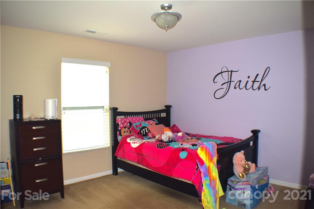 12021 Bending Branch Road Charlotte, NC 28227 - Photo 9 of 16 a bedroom with a bed and a baby crib