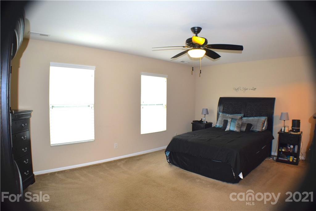 12021 Bending Branch Road Charlotte, NC 28227 - Photo 10 of 16 a bedroom with a bed lamp and a window