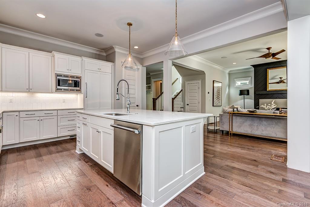736 Ellsworth Road, Unit 44 Charlotte, NC 28211 - Photo 14 of 36 a kitchen with stainless steel appliances granite countertop a sink and dishwasher a stove with wooden floors