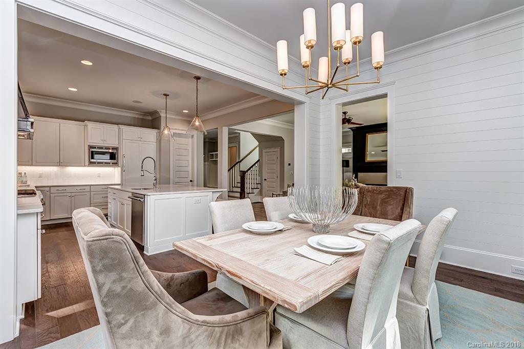 736 Ellsworth Road, Unit 44 Charlotte, NC 28211 - Photo 17 of 36 a dining room with furniture a chandelier and wooden floor
