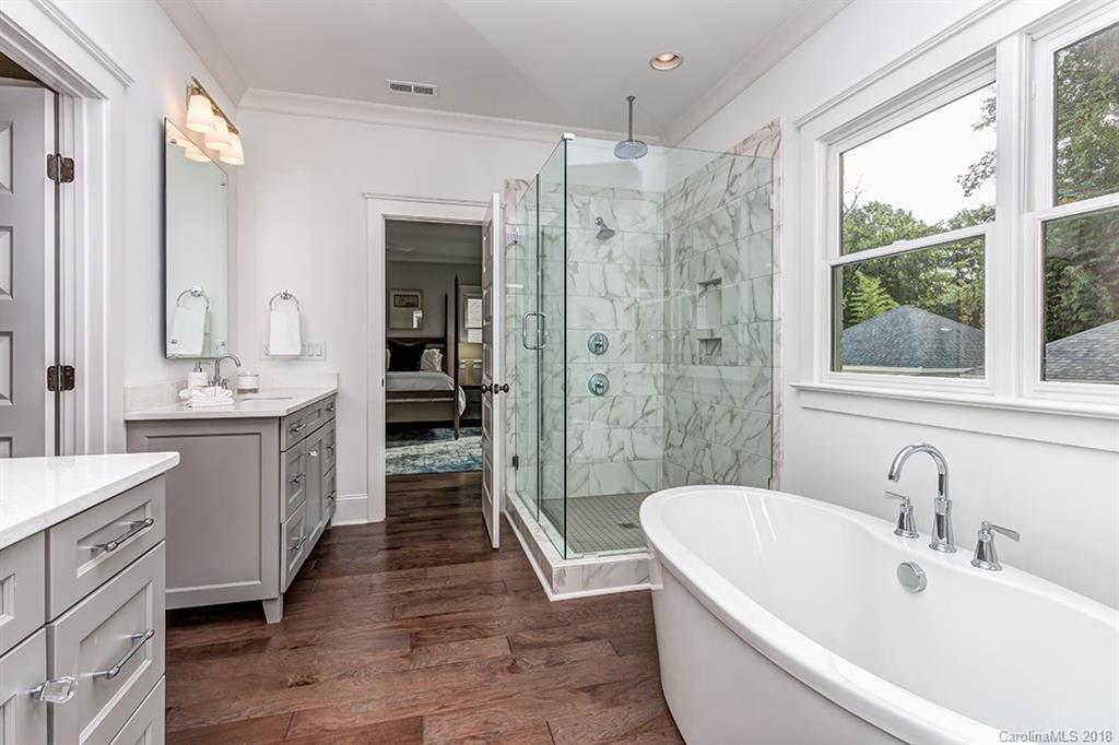 736 Ellsworth Road, Unit 44 Charlotte, NC 28211 - Photo 20 of 36 a bathroom with a tub sink shower and mirror