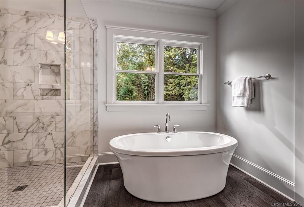 736 Ellsworth Road, Unit 44 Charlotte, NC 28211 - Photo 22 of 36 a white bath tub sitting next to a shower