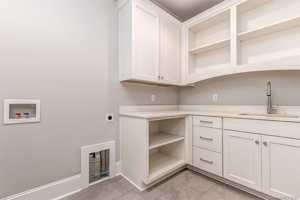 736 Ellsworth Road, Unit 44 Charlotte, NC 28211 - Photo 26 of 36 a kitchen with white cabinets and white appliances