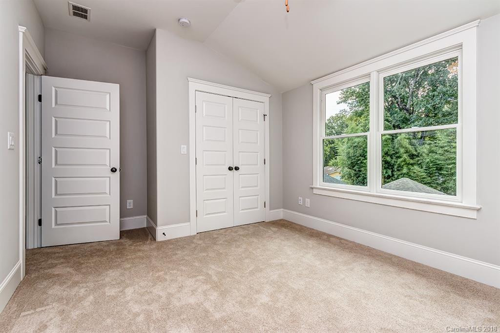 736 Ellsworth Road, Unit 44 Charlotte, NC 28211 - Photo 30 of 36 an empty room with closet and a window