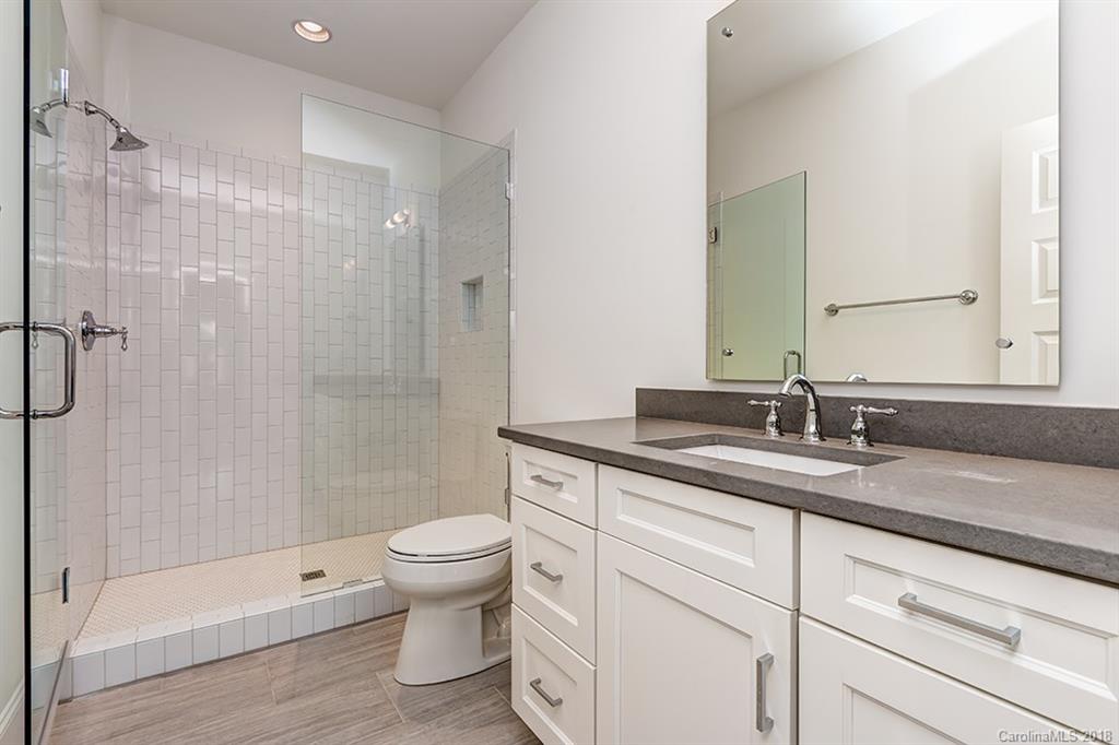 736 Ellsworth Road, Unit 44 Charlotte, NC 28211 - Photo 31 of 36 a bathroom with a double vanity sink toilet and shower