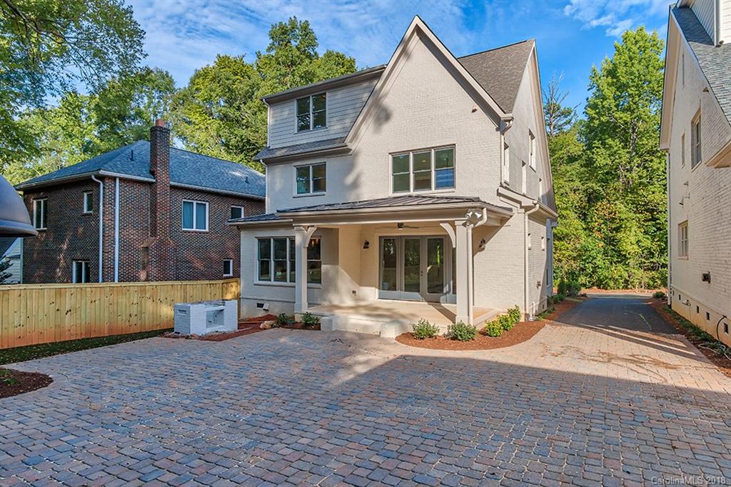 736 Ellsworth Road, Unit 44 Charlotte, NC 28211 - Photo 33 of 36 a view of a white house with large windows and plants