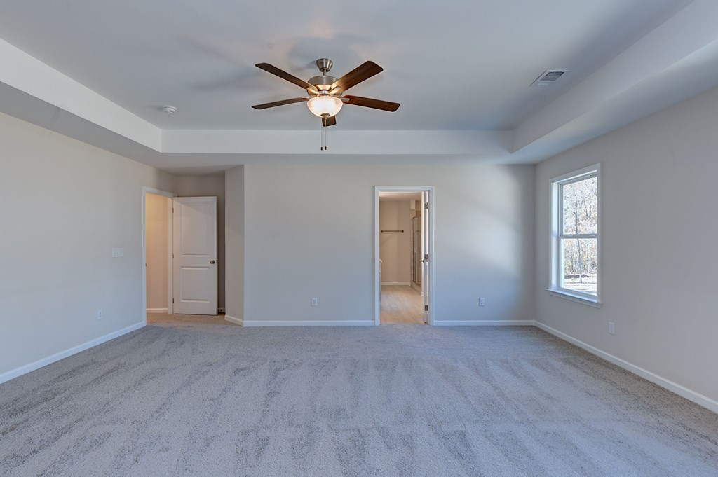 8701 McKee Road Upatoi, GA 31829 - Photo 21 of 35 a view of an empty room with wooden floor and a window