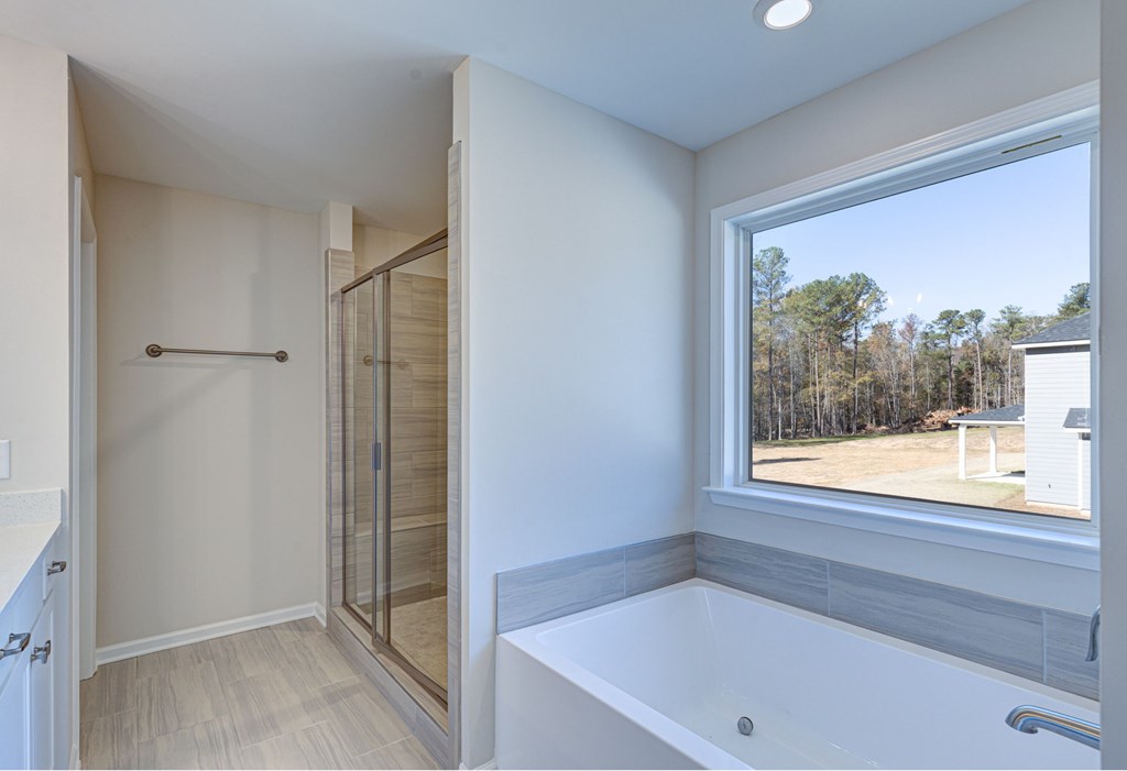 8701 McKee Road Upatoi, GA 31829 - Photo 23 of 35 a bathroom with a bathtub and a shower