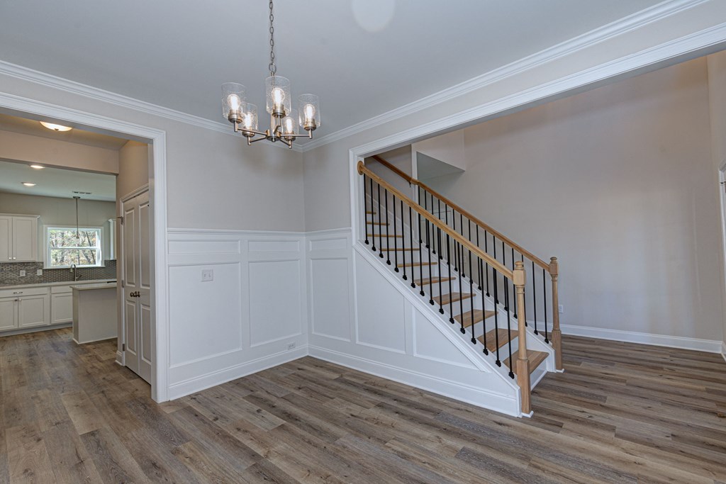 8701 McKee Road Upatoi, GA 31829 - Photo 3 of 35 a view of a livingroom with wooden floor and a kitchen