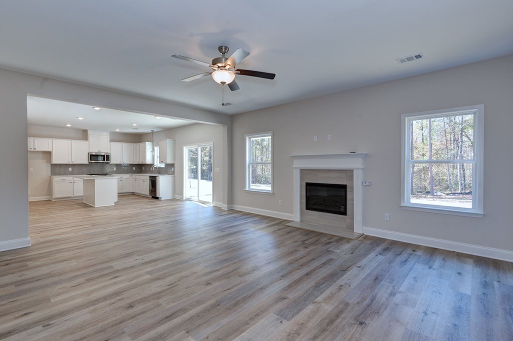 8701 McKee Road Upatoi, GA 31829 - Photo 6 of 35 a view of an empty room with a kitchen and a window