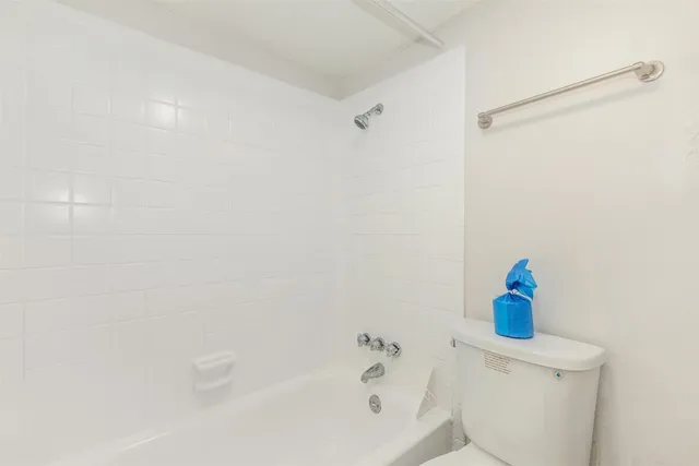 a bathroom with a shower and a toilet