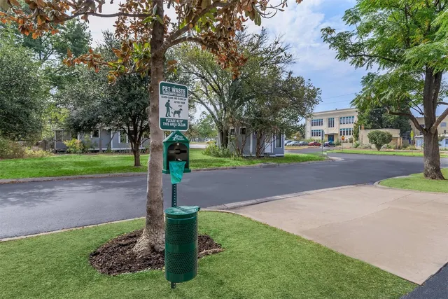 a front view of a house with a yard and tree s