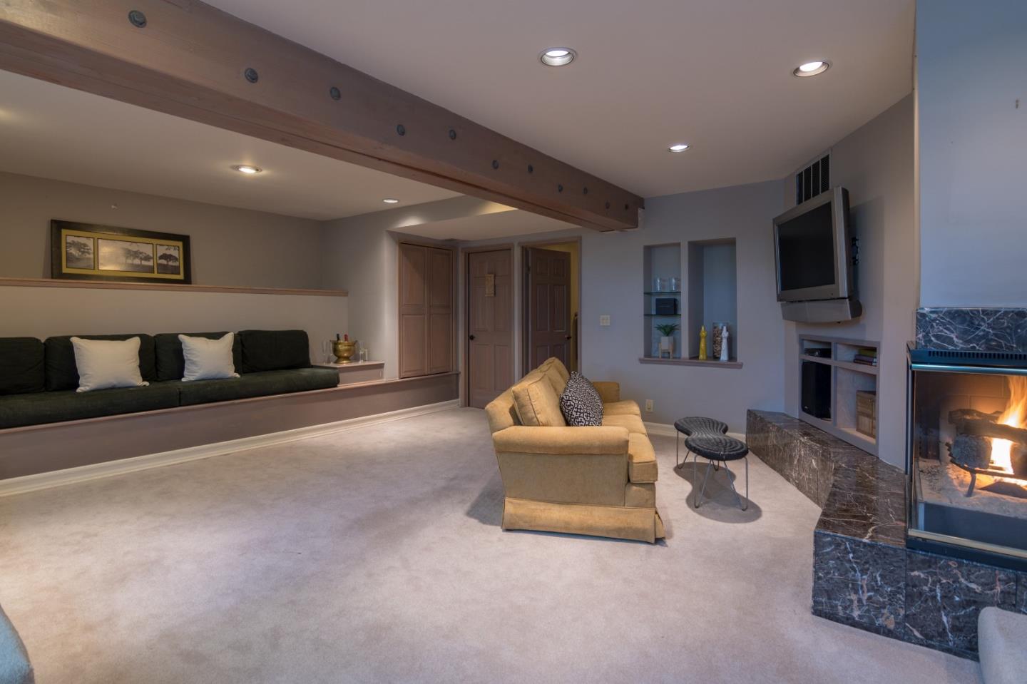 14795 Bohlman Road Saratoga, CA 95070 - Photo 20 of 50 a living room with furniture and a flat screen tv