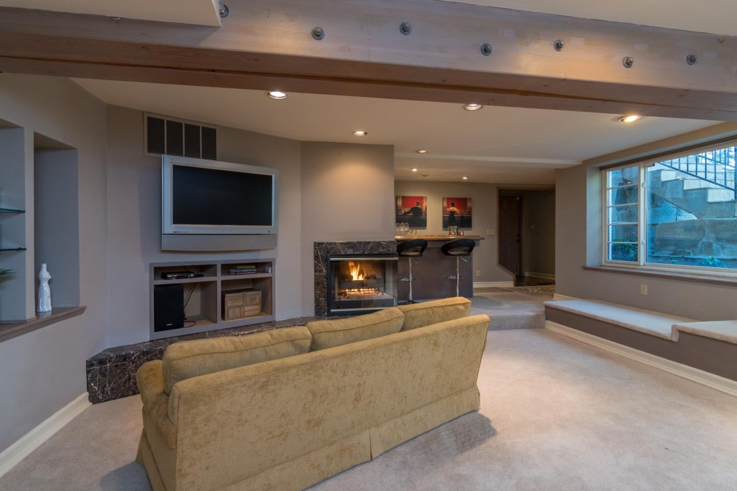 14795 Bohlman Road Saratoga, CA 95070 - Photo 22 of 50 a living room with fireplace furniture and a flat screen tv
