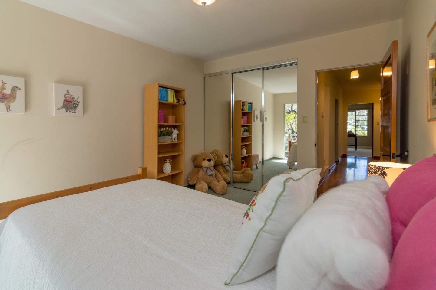14795 Bohlman Road Saratoga, CA 95070 - Photo 27 of 50 a bed room with a bed and a large mirror