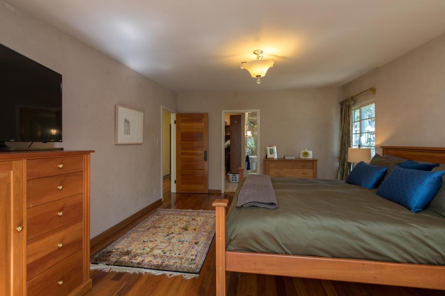 14795 Bohlman Road Saratoga, CA 95070 - Photo 30 of 50 a bedroom with a bed and a flat screen television