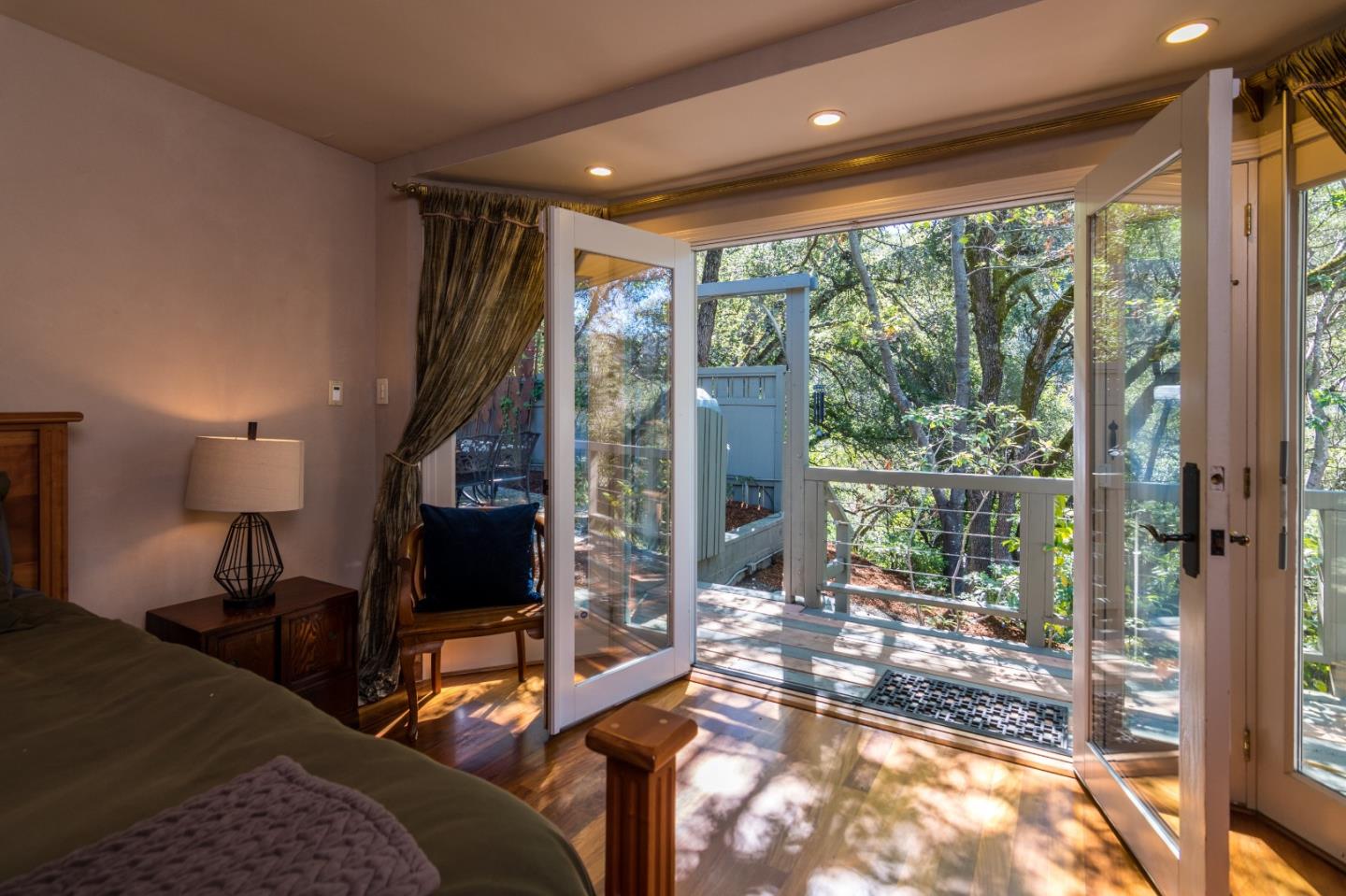 14795 Bohlman Road Saratoga, CA 95070 - Photo 31 of 50 a living room with furniture tv and a floor to ceiling window