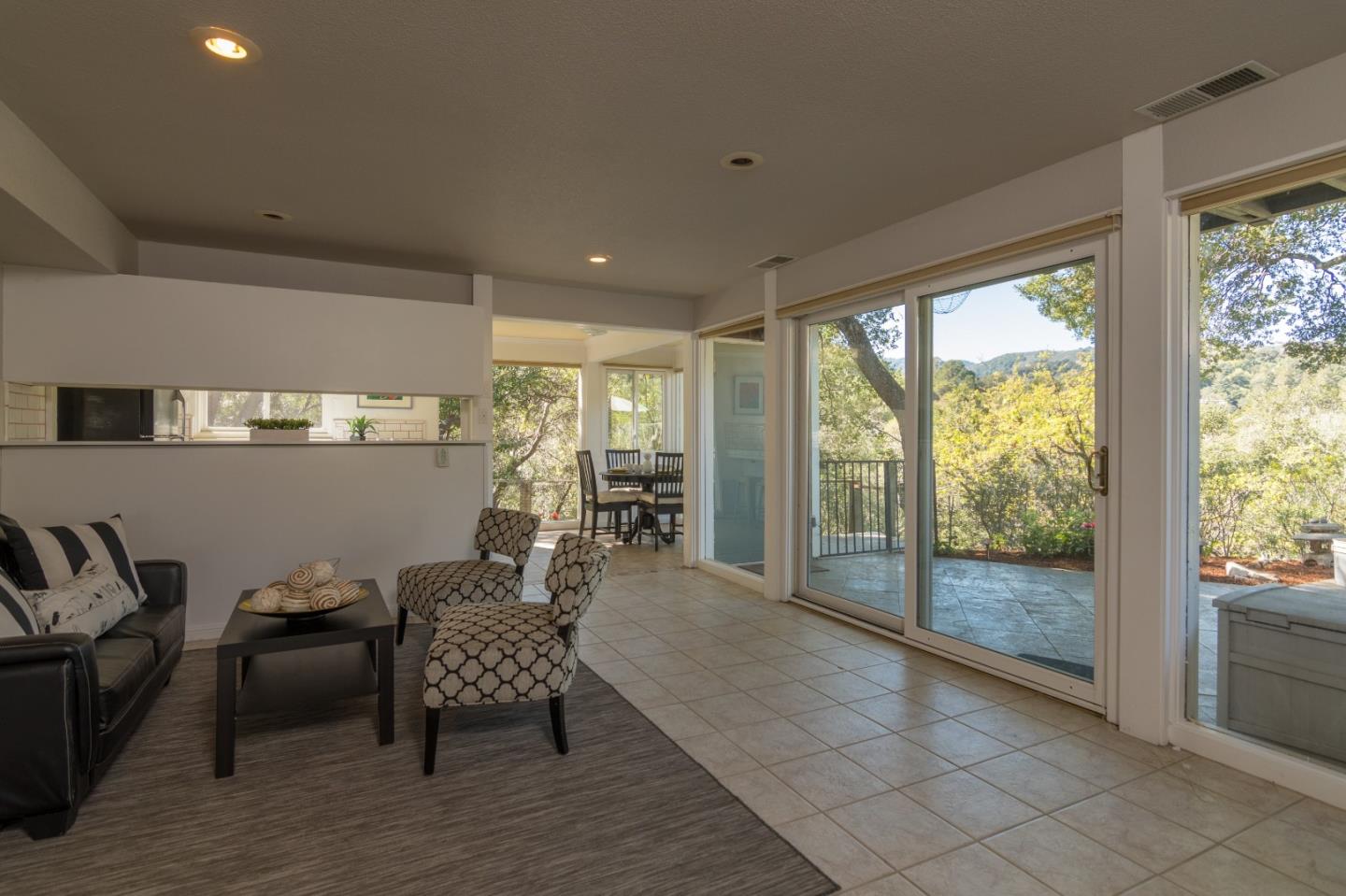 14795 Bohlman Road Saratoga, CA 95070 - Photo 35 of 50 a living room with furniture and a floor to ceiling window