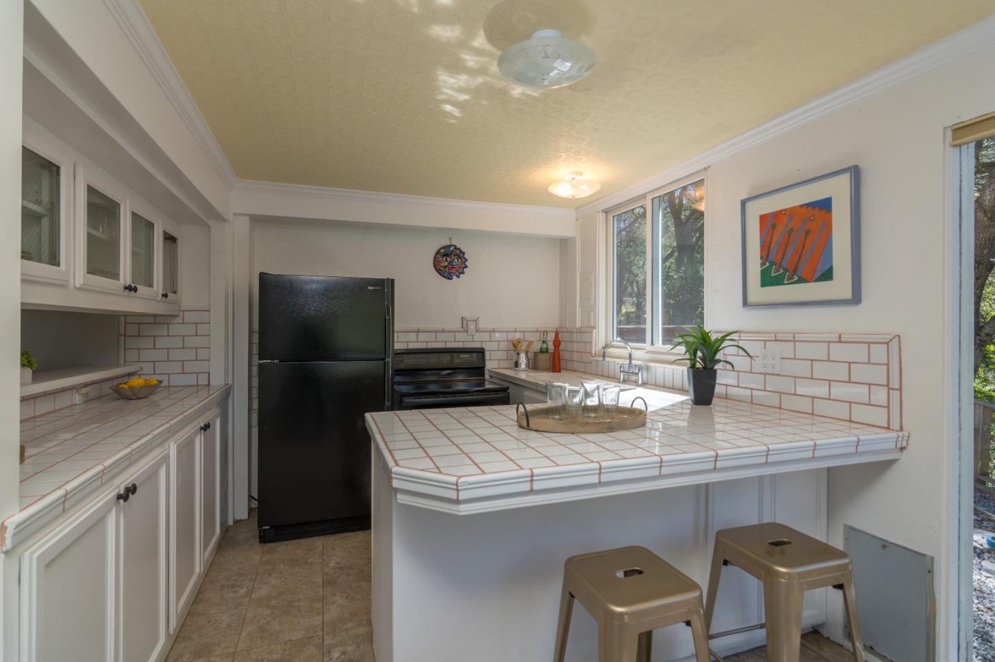 14795 Bohlman Road Saratoga, CA 95070 - Photo 37 of 50 a kitchen with stainless steel appliances a sink stove and refrigerator