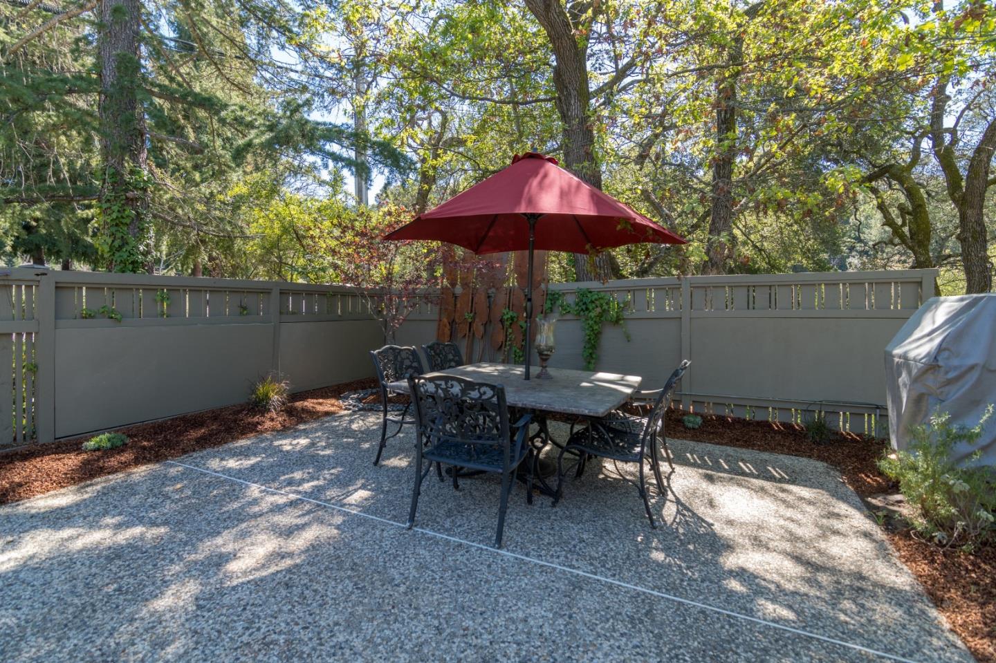 14795 Bohlman Road Saratoga, CA 95070 - Photo 39 of 50 an outdoor sitting area with umbrella and umbrella