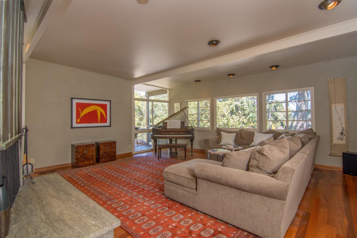 14795 Bohlman Road Saratoga, CA 95070 - Photo 8 of 50 a living room with furniture a rug and a flat screen tv