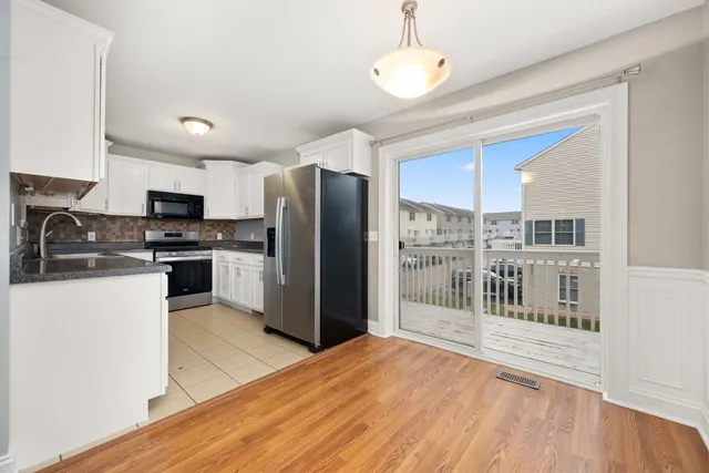 a kitchen with stainless steel appliances a refrigerator and a stove top oven