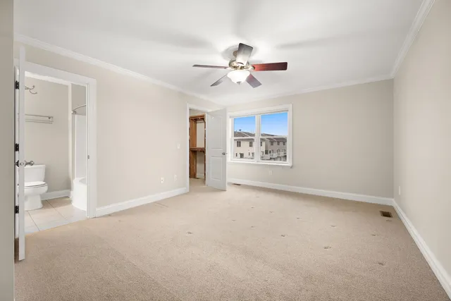 a view of an empty room and a ceiling fan window