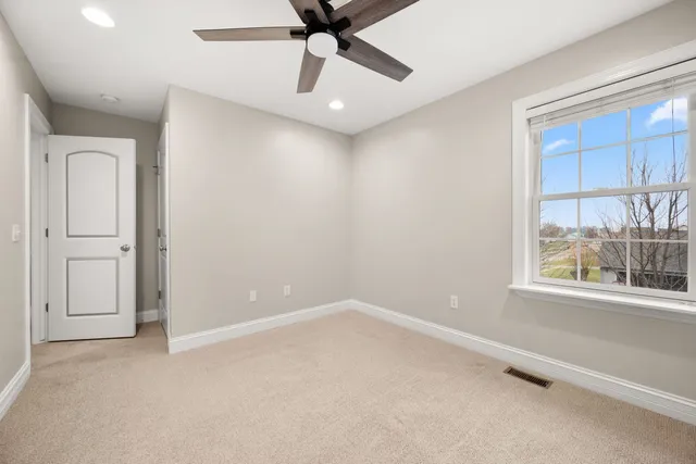 an empty room with windows and closet
