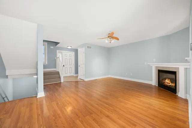 a view of an empty room and wooden floor