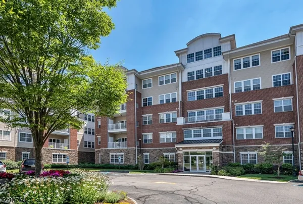 a front view of a residential apartment building with a yard