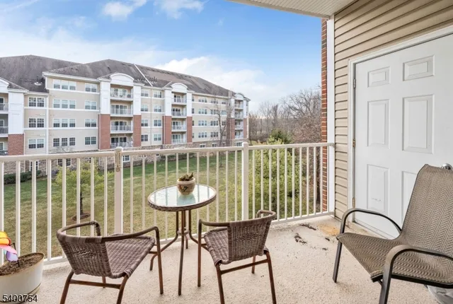 a view of a chairs and table in a balcony