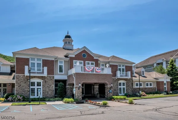 a front view of a building with parking space and parking