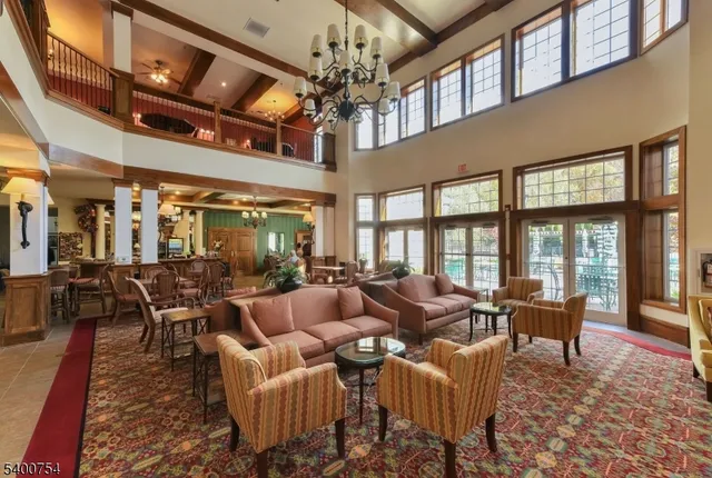 a living room with furniture or chandelier and a dining table