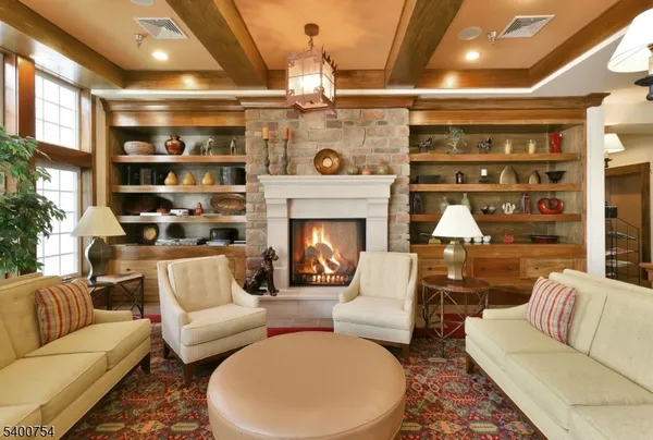 a living room with furniture a fireplace and a table