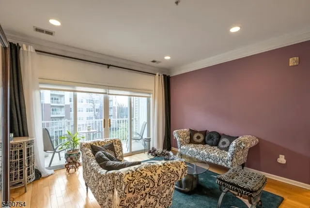 a living room with furniture and a floor to ceiling window
