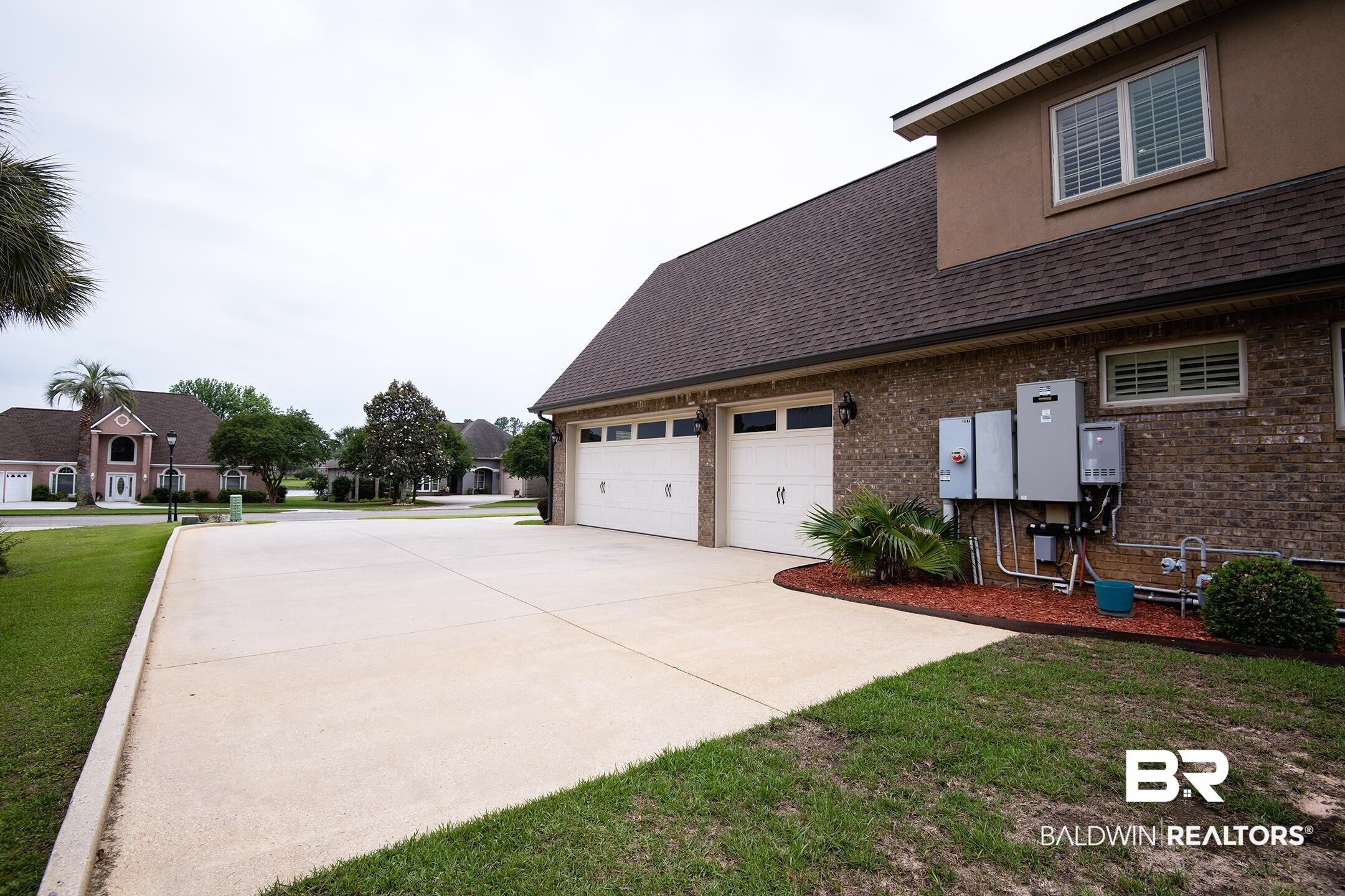 9357 Lakeview Drive Foley, AL 36535 - Photo 20 of 68 Brick exterior with a two-car garage and a concrete driveway