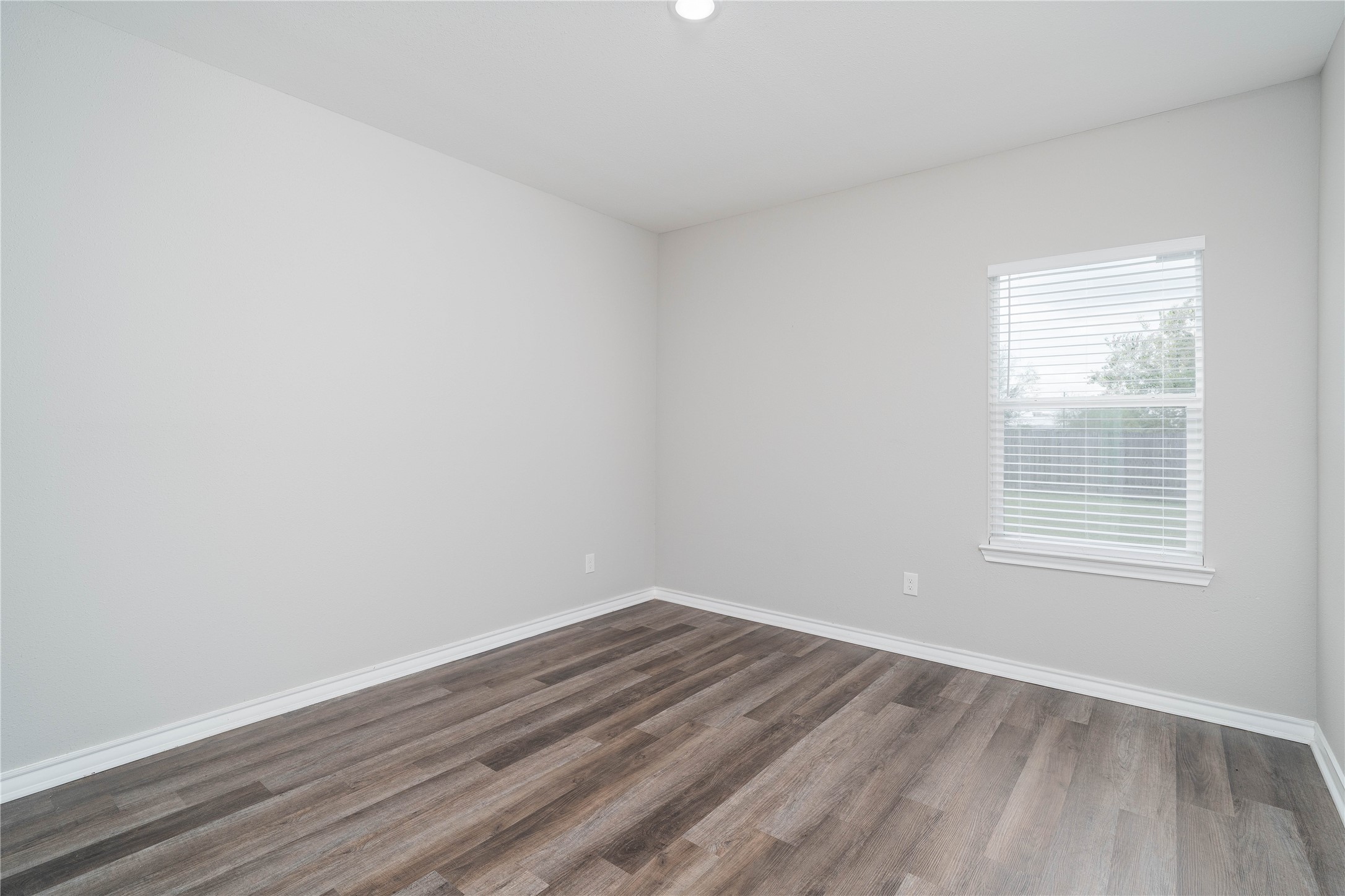 231 McCormick Street Columbus, TX 78934 - Photo 24 of 27 Bedroom – Generously sized bedroom with wide plank flooring, soft natural light, and a versatile layout to suit various needs.