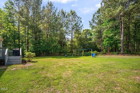 a view of a yard with large trees