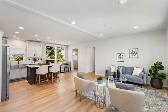 a living room with furniture dining table and a potted plant