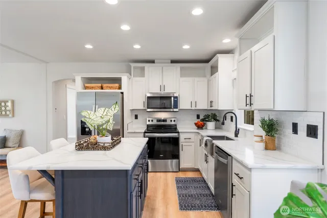 a kitchen with a sink a stove and cabinets