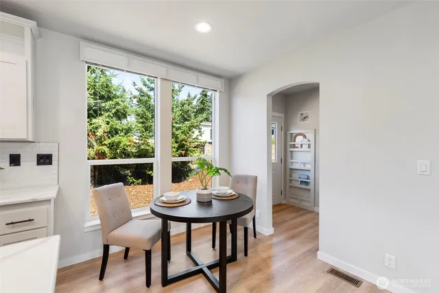 a view of a dining room with furniture and window