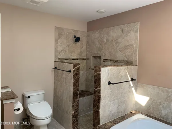 a white toilet sitting next to a bathroom sink