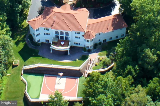 an aerial view of a house with swimming pool garden and patio