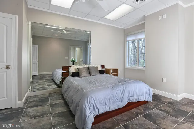 a bedroom with a bed and a mirror