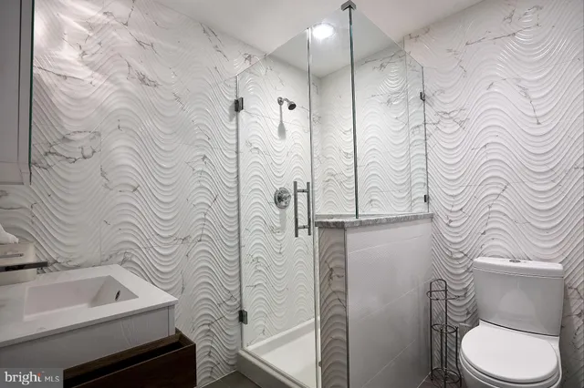 a bathroom with a toilet sink and shower