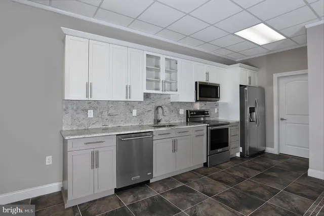 a kitchen with a sink stove and refrigerator